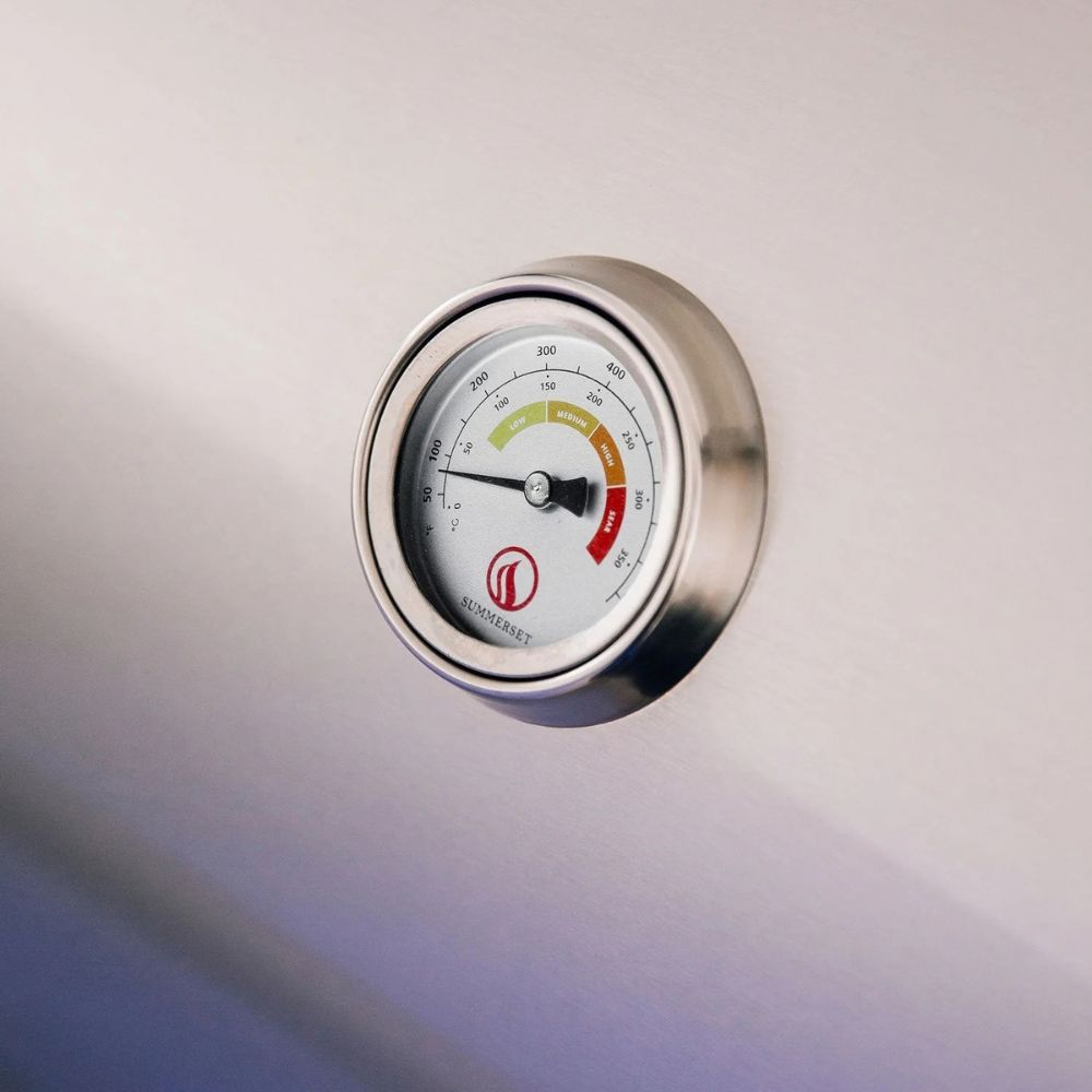 Thermometer on a metallic surface with a visible brand logo.