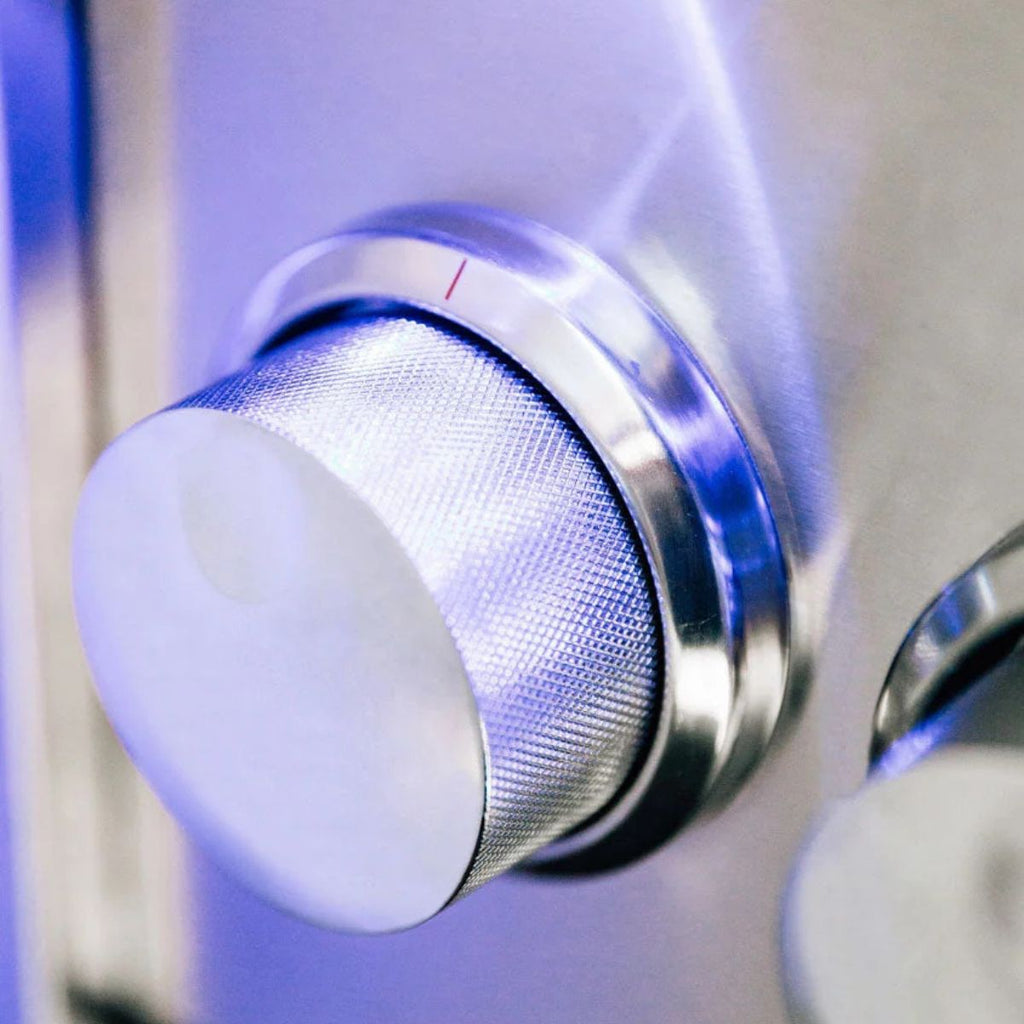 Close-up of a shower control knob with a blurred background