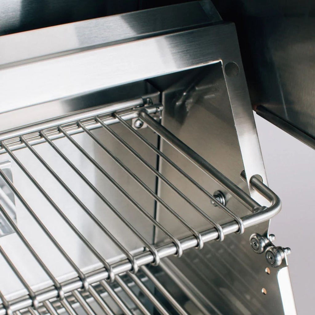 Close-up of a stainless steel wire shelf mounted inside a matching stainless steel appliance or enclosure.