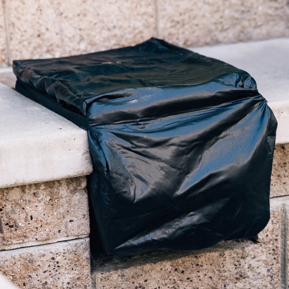 Black trash bag on a stone ledge