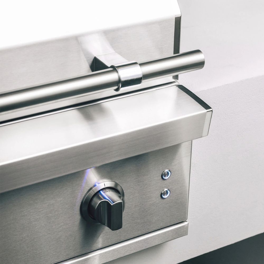 Stainless steel control panel with knob and light indicator on a white background