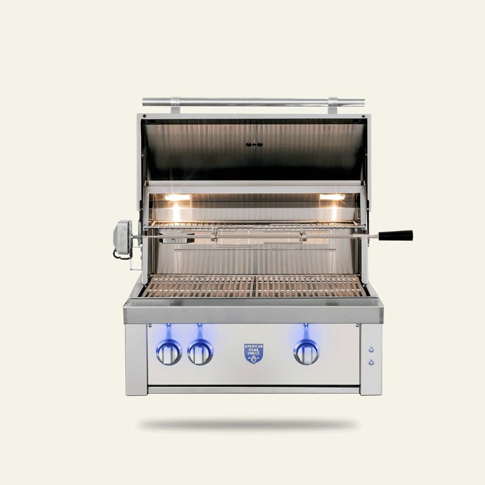 A stainless steel gas grill with its lid open, showing the interior grates and glowing burners. The grill features a control panel with three blue-tinted knobs and a small blue logo badge on the front, set against a solid off-white background.