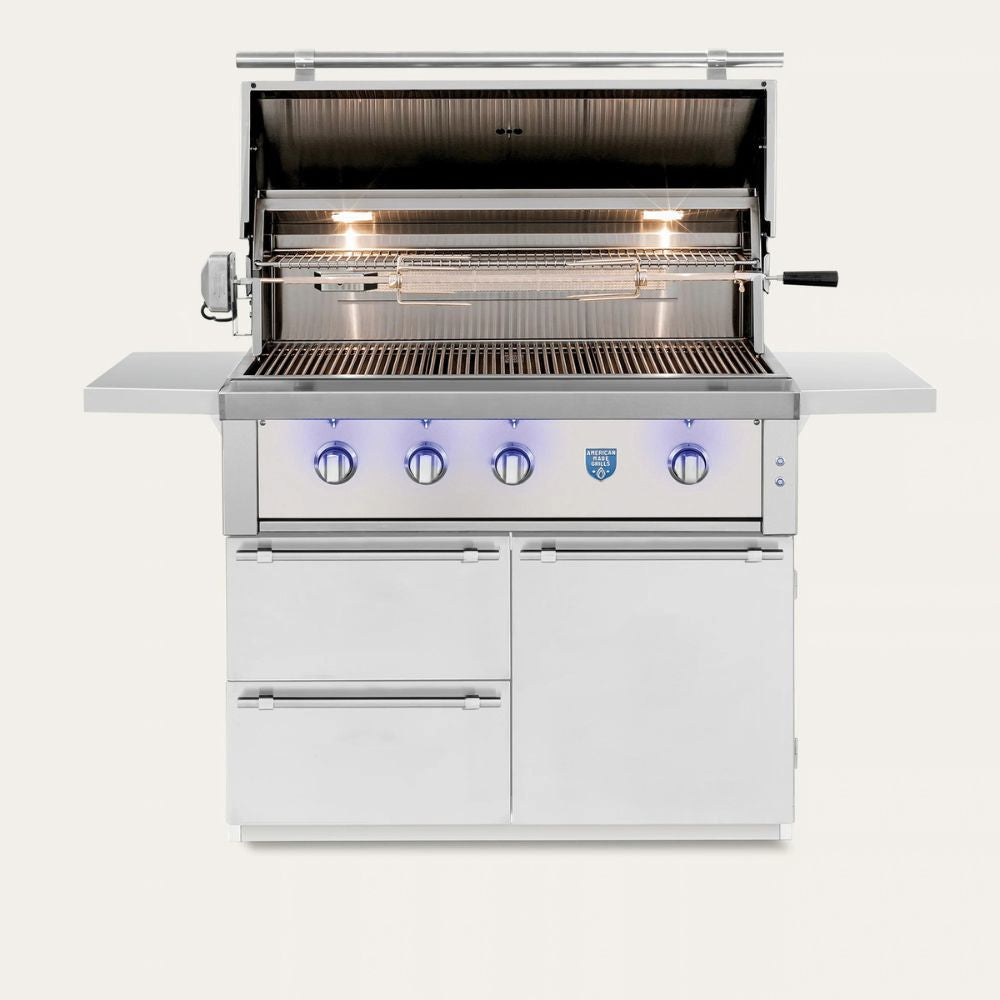 A stainless steel outdoor gas grill with an open lid, lit burners, side shelves, and a white lower cabinet base with four control knobs and blue accent lighting, shown on a plain light background.