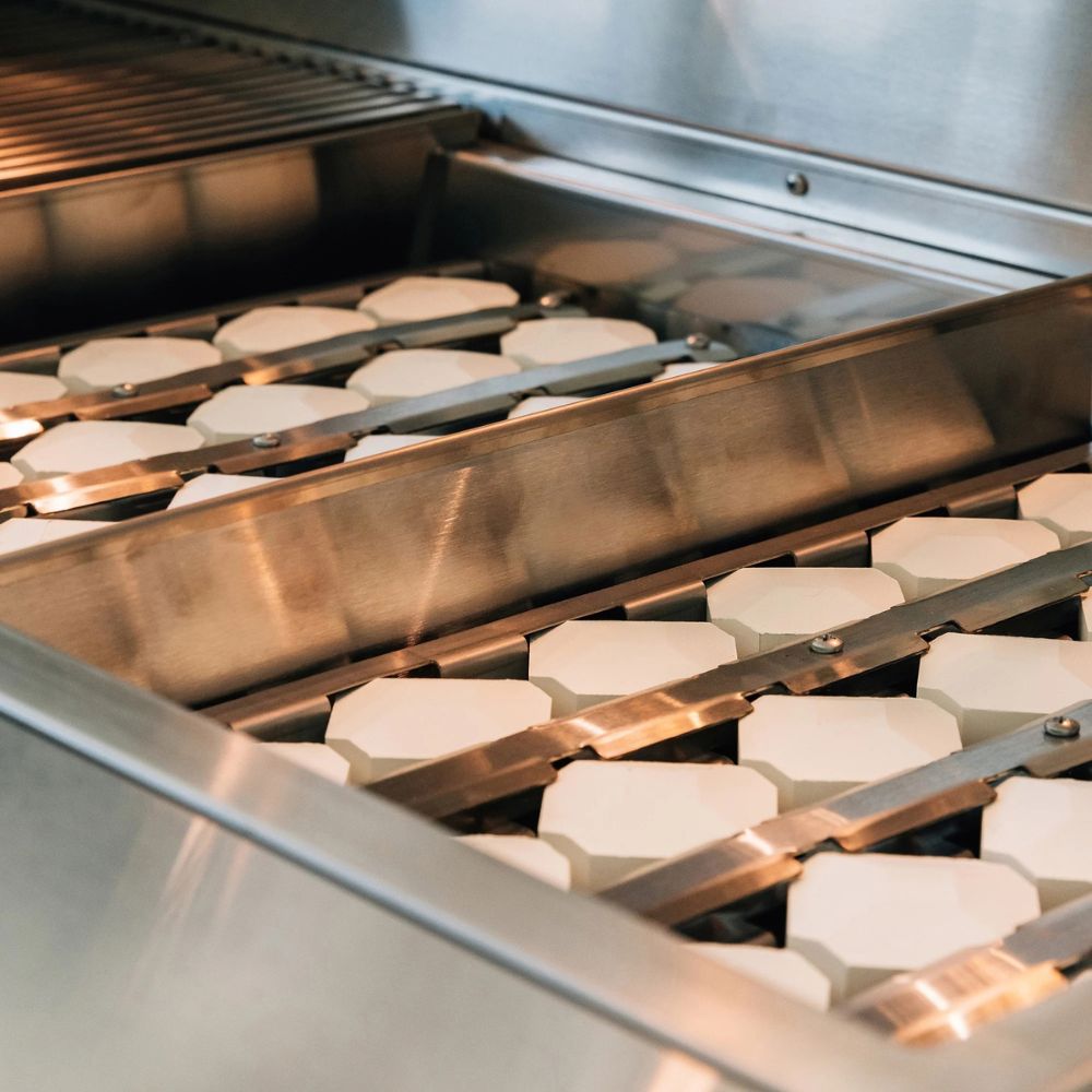 Baked goods on a conveyor belt in an industrial setting