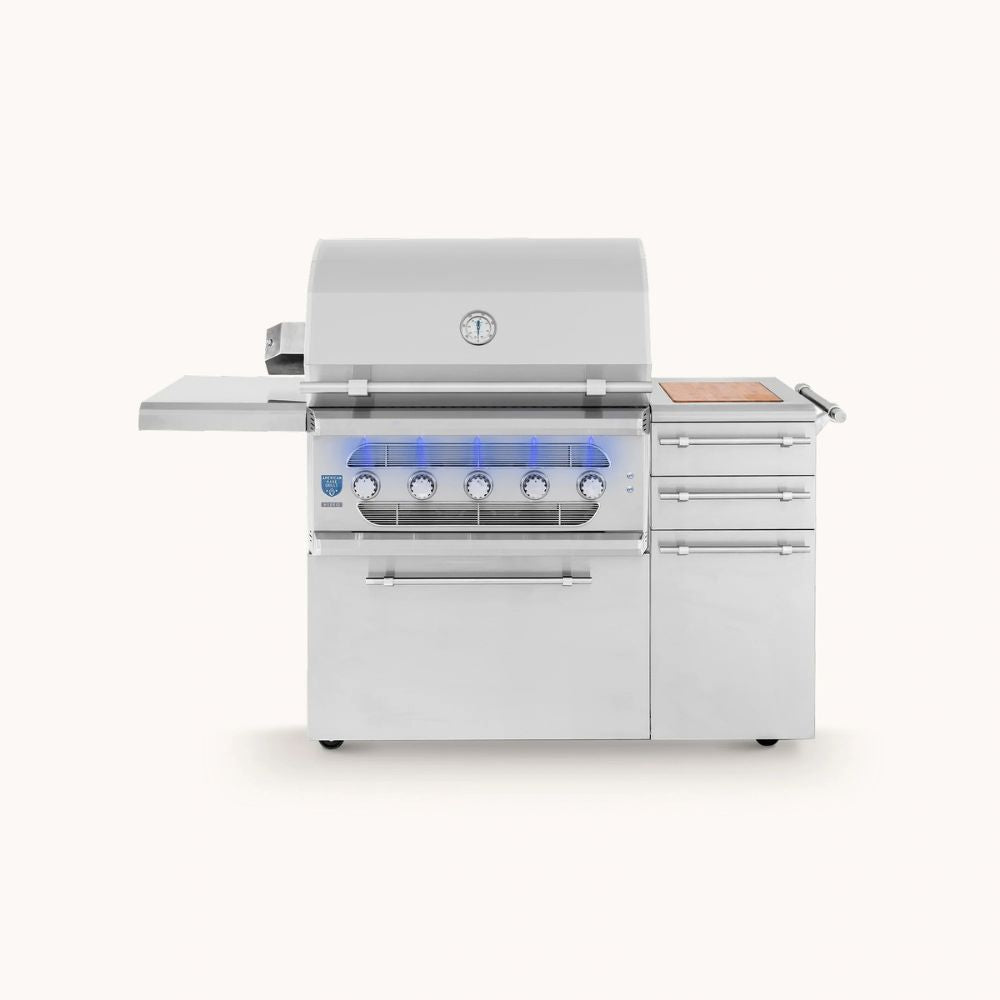 A stainless steel outdoor gas grill with a side shelf, three drawers, and blue LED lighting under the control panel, shown on a light beige background.