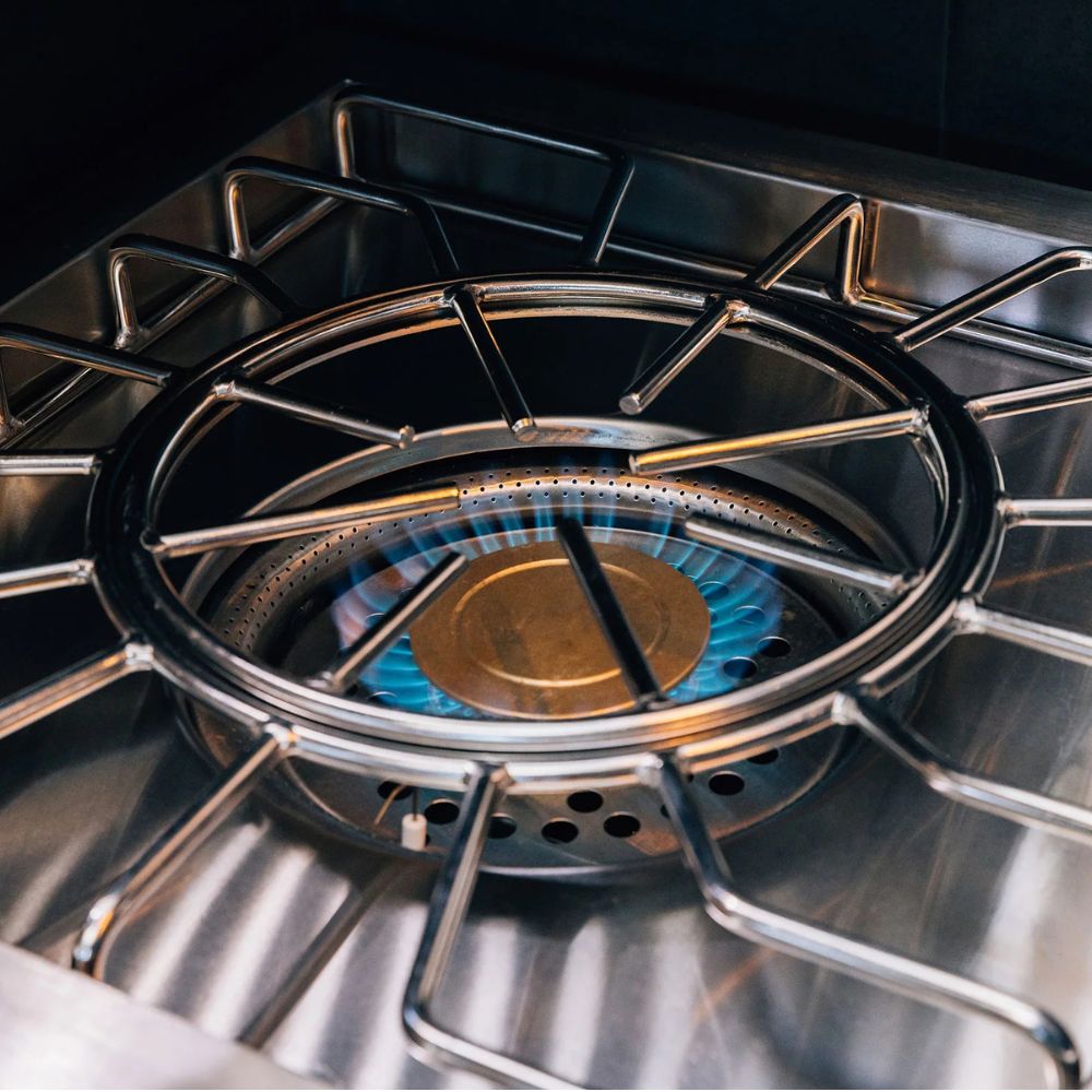 Close-up of a gas stove burner with visible flame