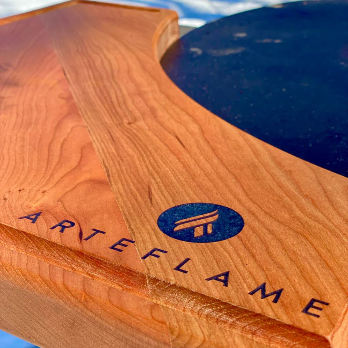 Wooden product with 'ARTEFLAME' branding on a blue background