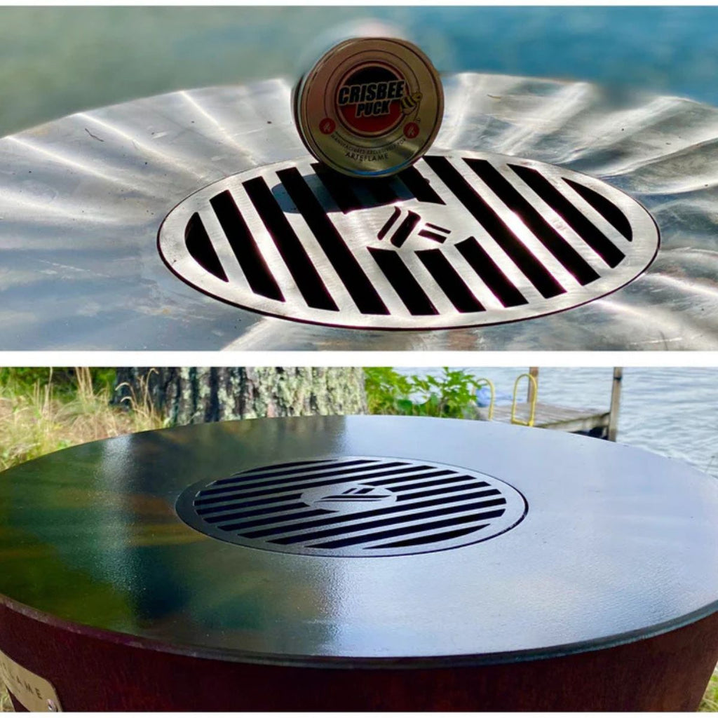 Metal fire pit with a visible brand logo against a natural background
