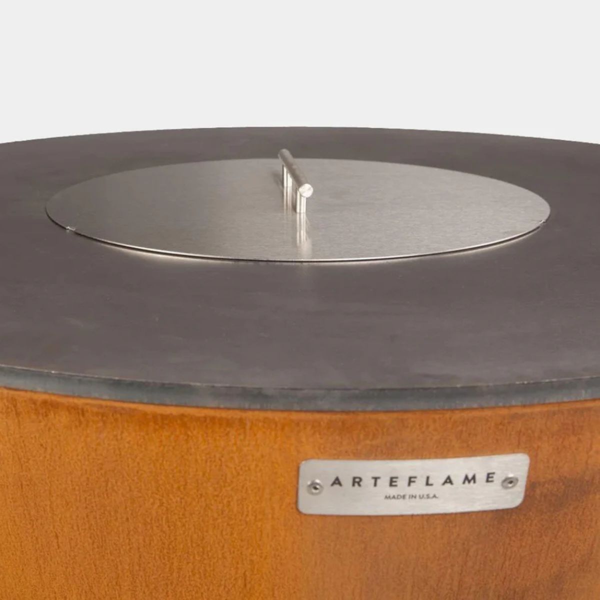 Close-up of a fire pit with a metal top and 'Arteflame' label on a white background
