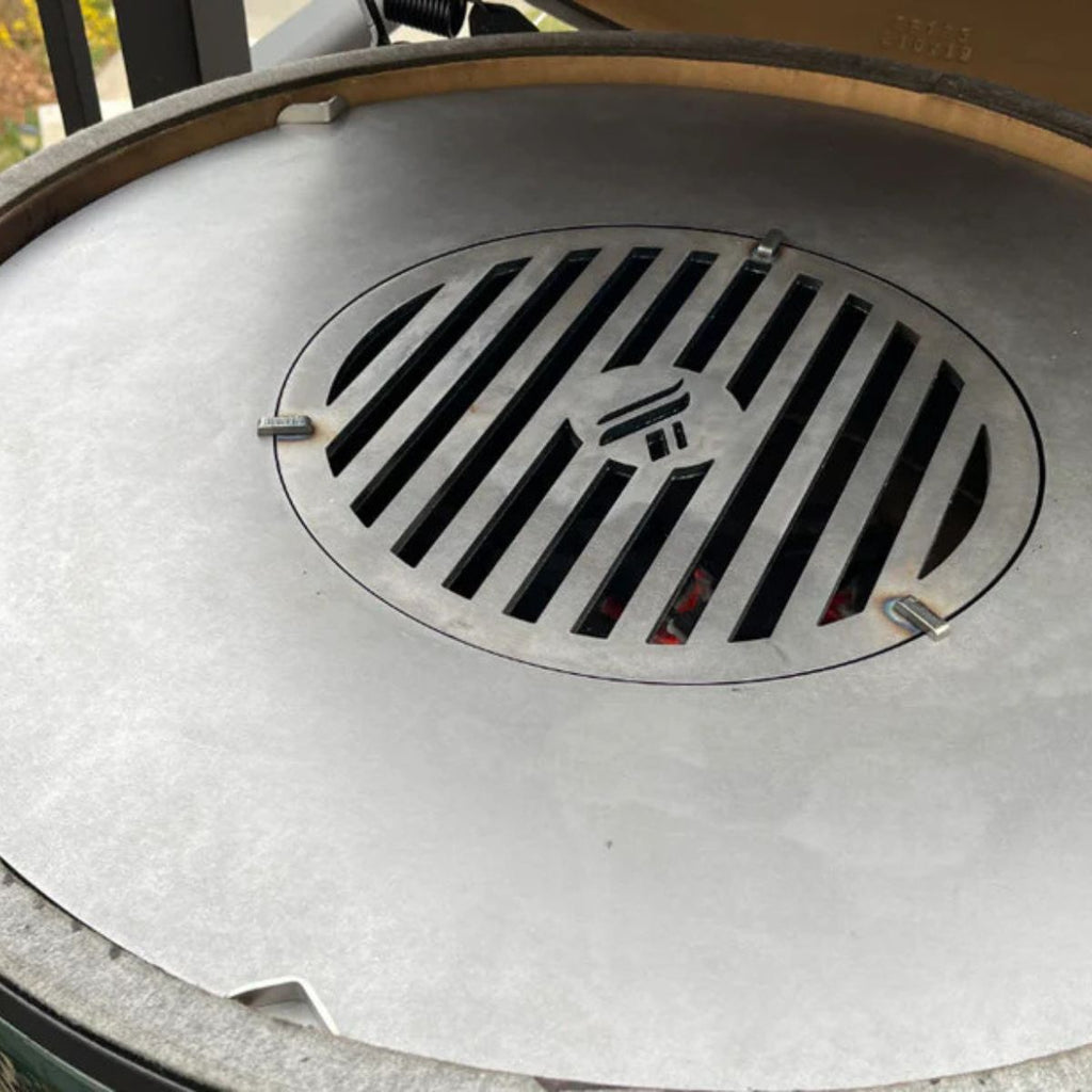 Close-up of a metal grill lid with a brand logo on a barbecue.
